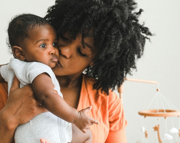 A Black mother kissing her baby's face. Photo credit Pexels